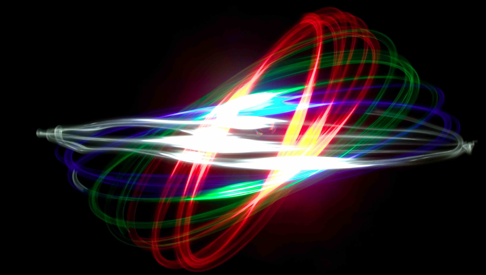 Chaotically swirling light trails in the triangulation colors red, green and blue.