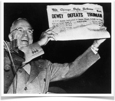 Harry Truman holds up the newspaper with the false headline "Dewey Defeats Truman